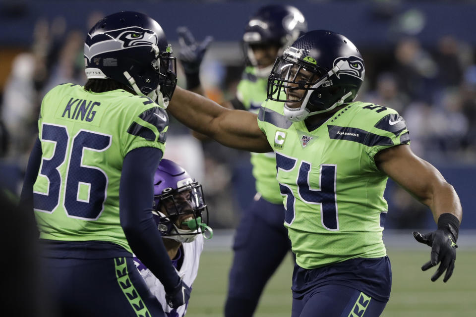 Seattle Seahawks middle linebacker Bobby Wagner, right, reacts with cornerback Akeem King (36) after the Minnesota Vikings failed to convert on a fourth-down play during the second half of an NFL football game, Monday, Dec. 2, 2019, in Seattle. The Seahawks won 37-30. (AP Photo/Ted S. Warren)