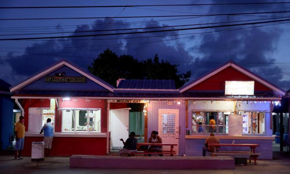 People relax outside restaurants in Bridgetown