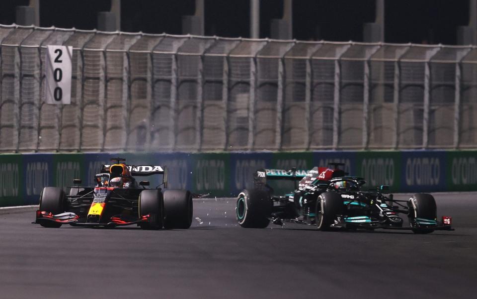 Max Verstappen of the Netherlands driving the (33) Red Bull Racing RB16B Honda and Lewis Hamilton of Great Britain driving the (44) Mercedes AMG Petronas F1 Team Mercedes W12 collide during the F1 Grand Prix of Saudi Arabia at Jeddah Corniche Circuit on December 05, 2021 in Jeddah, Saudi Arabia - Lars Baron/Getty Images