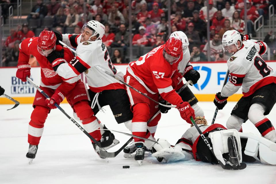 Ottawa Senators right wing Mathieu Joseph (21) hits Detroit Red Wings center Dylan Larkin (71) in the first period at Little Caesars Arena on Saturday, Dec. 9, 2023.