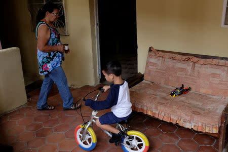 Andrew Miranda rides a bike at his grandmother's home in the slum of La Vega in Caracas, Venezuela November 16, 2018. Picture taken November 16, 2018. REUTERS/Marco Bello