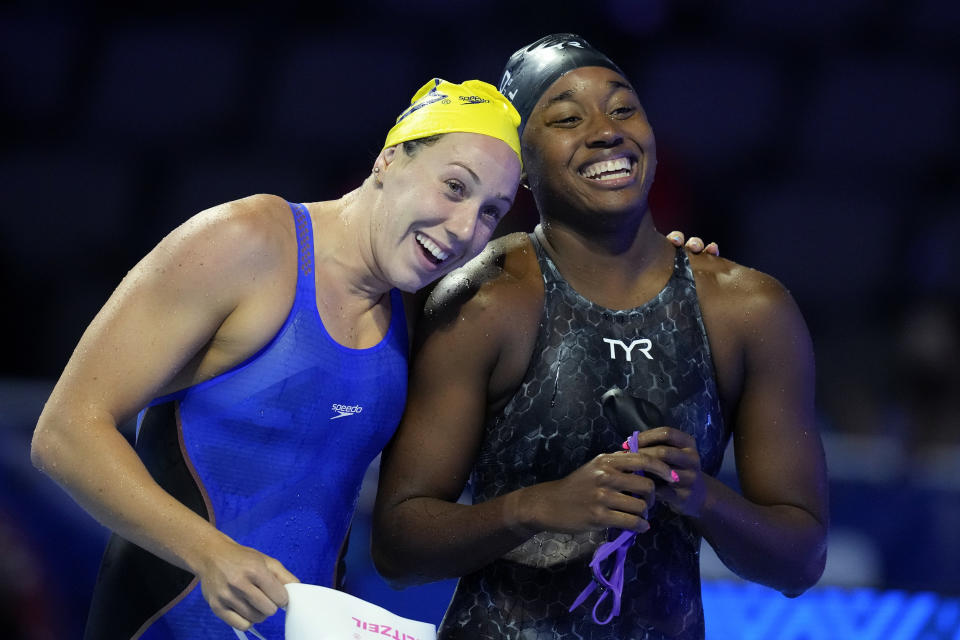 Abbey Weitzeil laughs with Simone Manuel, right, after competing in a women's 50-meter freestyle preliminary heat during wave 2 of the U.S. Olympic Swim Trials on Saturday, June 19, 2021, in Omaha, Neb. (AP Photo/Charlie Neibergall)