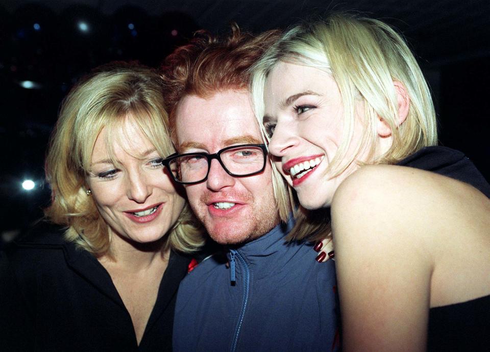 Library filer dated 1/12/96 of winner Chris Evans (Top C4/BBC2 Entertainment Presenter) being hugged by award presenters Gaby Roslin (left) and Zoe Ball at the British Comedy Awards 1996 at the London Television Centre. It was announced today (Thur), that Evans is to leave Radio One on March 27, the BBC said. Evans wanted to have every Friday off from presenting his Breakfast Show but BBC Radio 1 controller Matthew Bannister refused.  Mr Bannister told Evans it did not fit in with his plans for the station's schedule. See PA story SHOWBIZ Evans. Photo by David Cheskin/PA.   (Photo by David Cheskin - PA Images/PA Images via Getty Images)