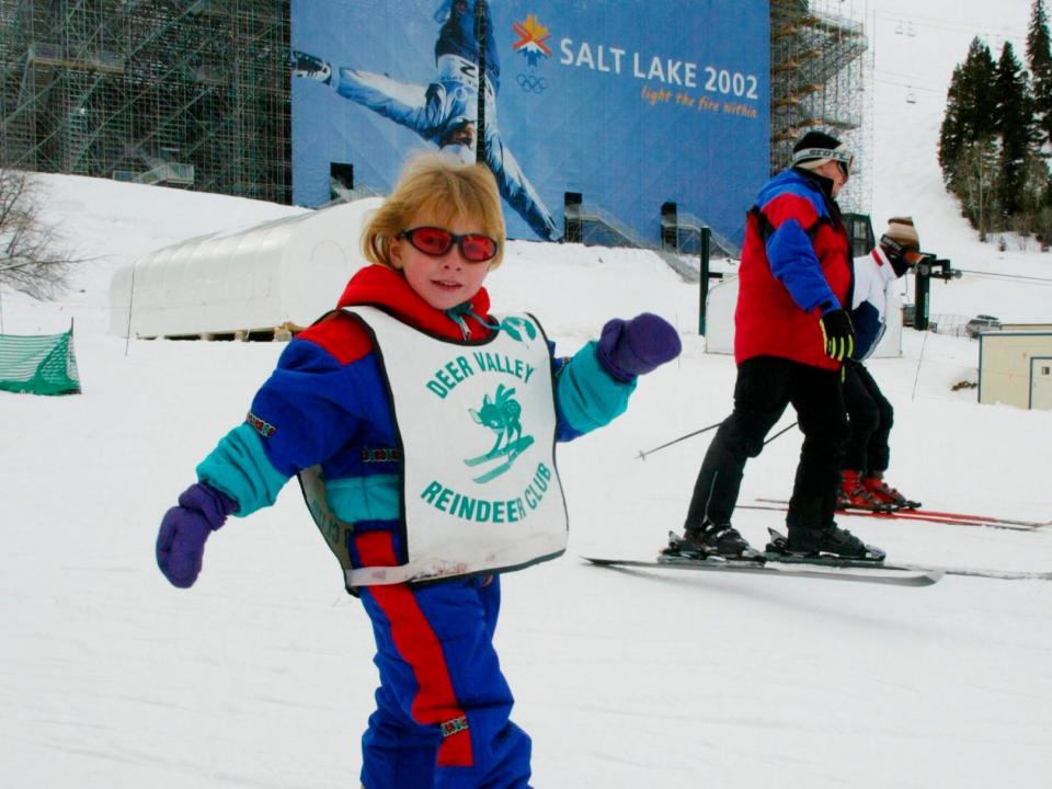 A young skier slides below the huge temporary stadium built at the Deer Valley ski resort in Utah