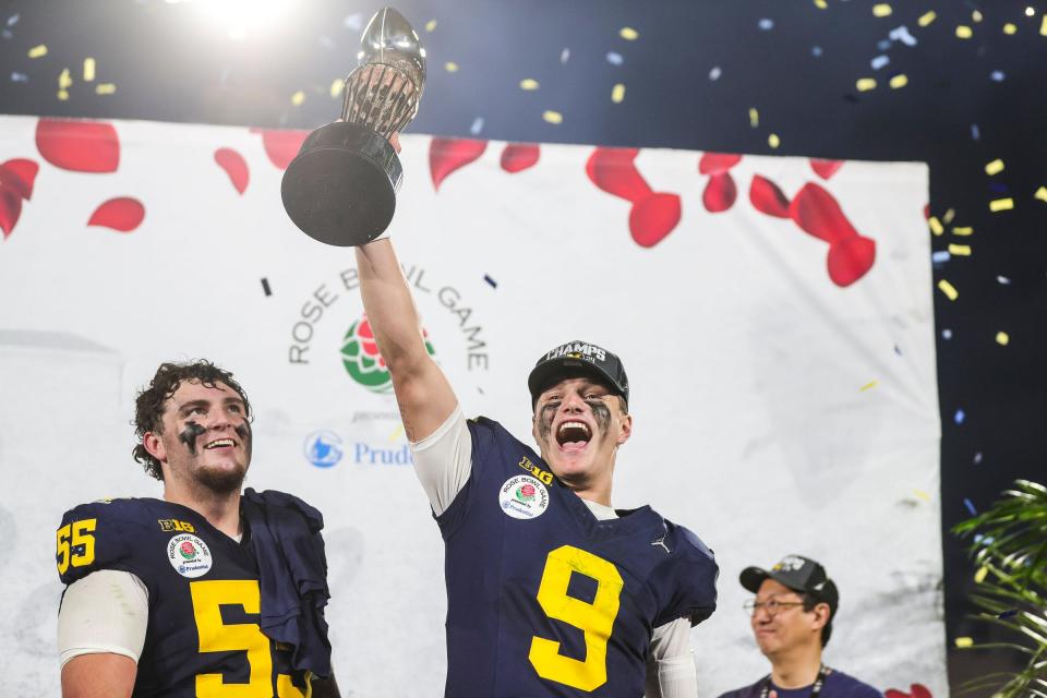 Michigan quarterback J.J. McCarthy lifts the Rose Bowl trophy to celebrate after the 27-20 overtime win in the Rose Bowl over Alabama at Rose Bowl Stadium in Pasadena, California, on Monday, Jan. 1, 2024.