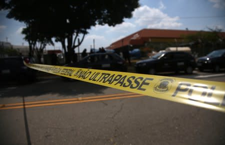 The entrance of the Viracopos airport freight terminal is seen blocked after an armed gang robbed a securities company in Campinas