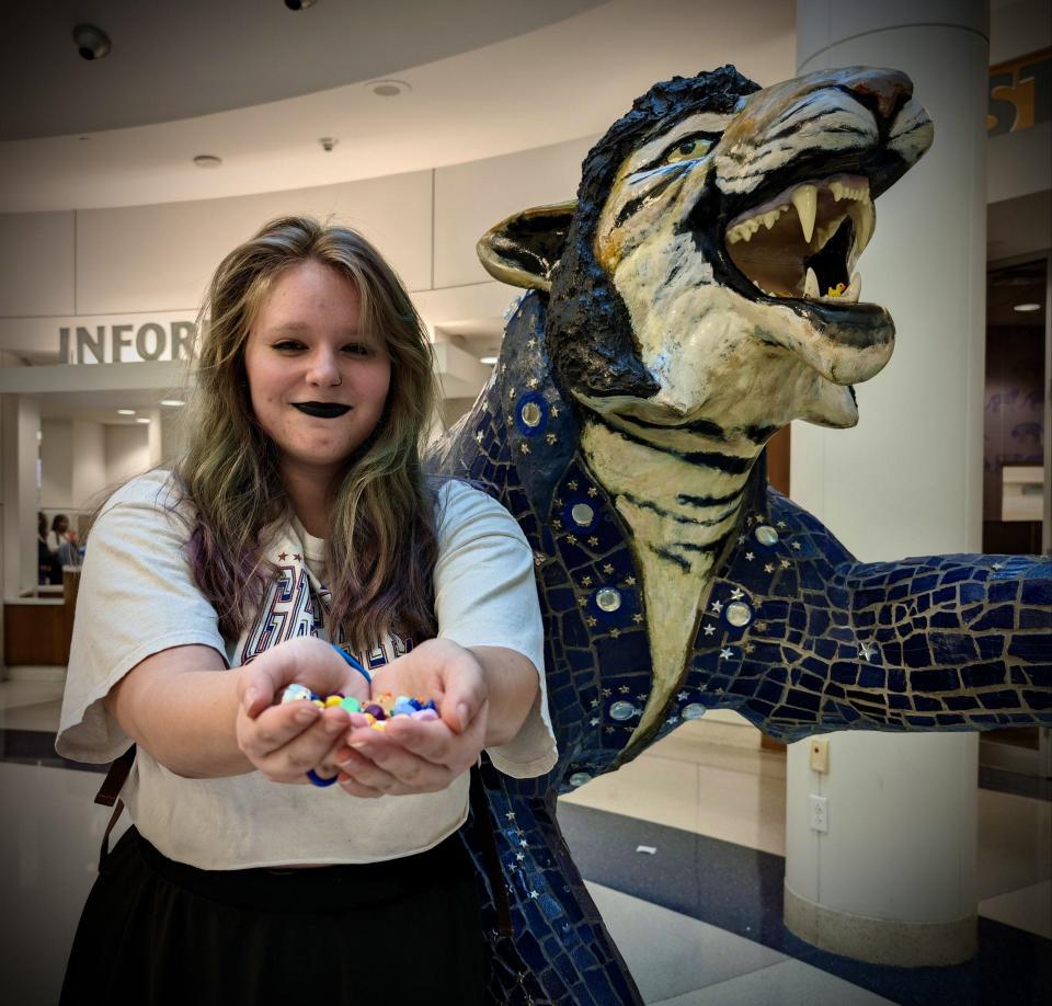 University of Memphis student Isabella Albert displays her tiny ducks next to an Elvis-inspired tiger statue inside the University Center.