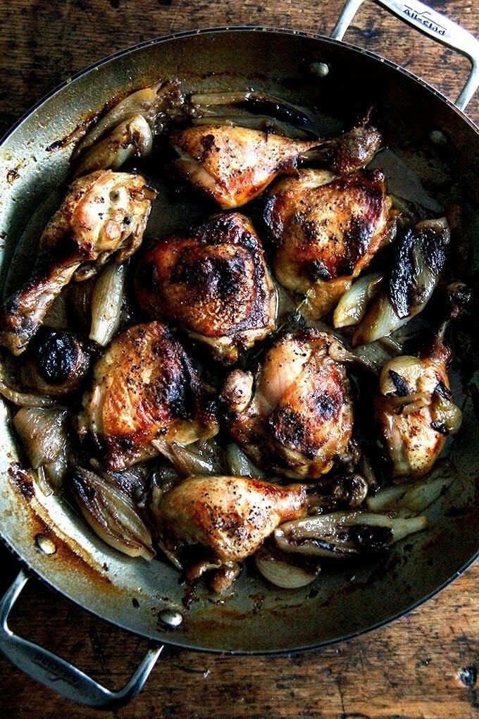 Cooked chicken and onions in a skillet