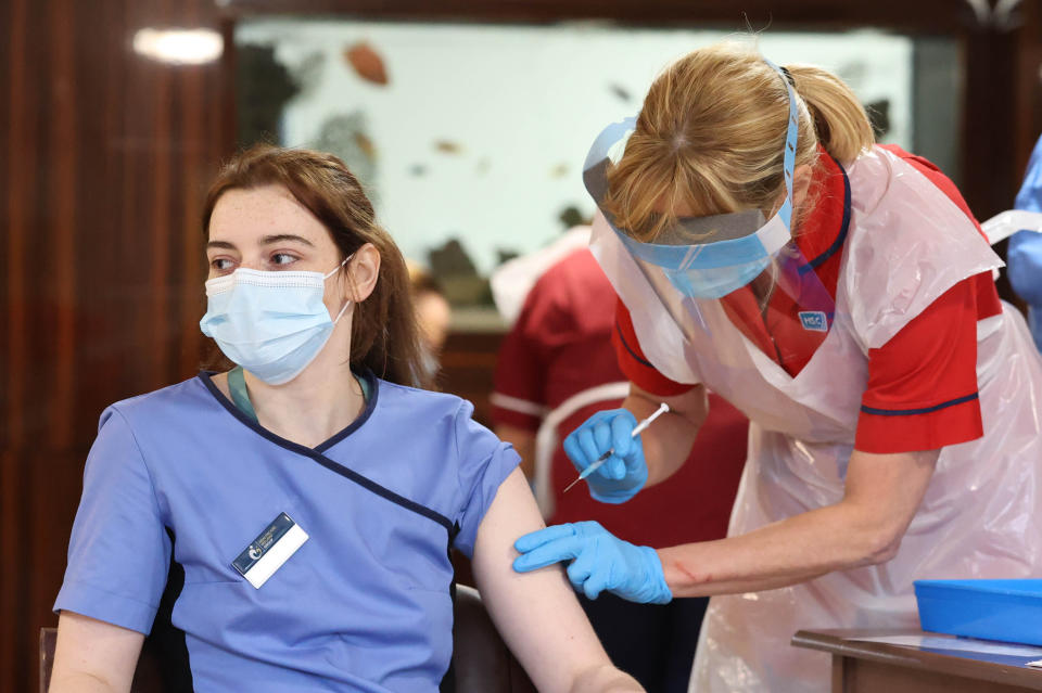 NAME TAG PIXELATED BY PA PICTURE DESK Care home staff receive the Pfizer/BioNtech covid-19 vaccine at Bradley Manor residential care home in Belfast. (Photo by Liam McBurney/PA Images via Getty Images)