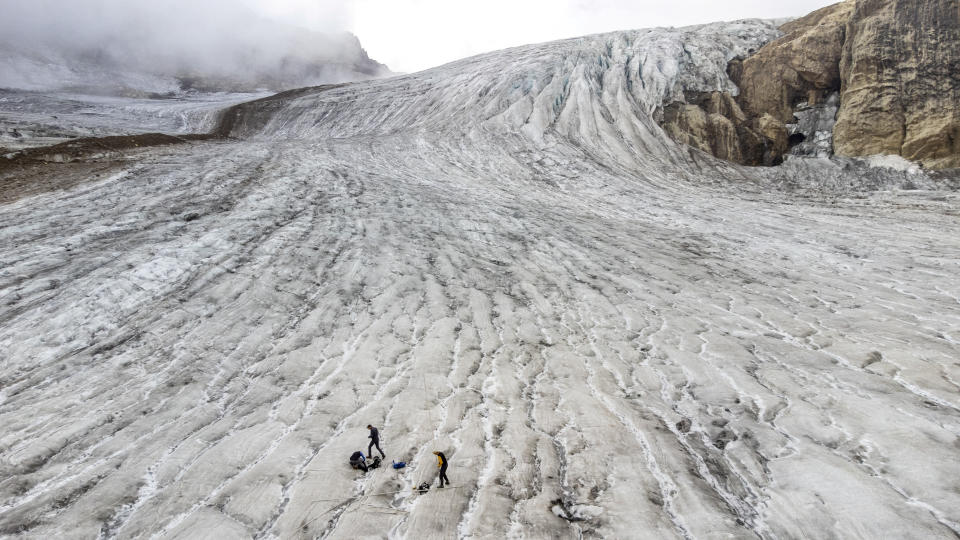 Glaciologist Matthias Huss together with members of the Glacier Monitoring in Switzerland (GLAMOS) Romain Hugonnet and Andreas Linsbauer check measuring equipment on the Gries glacier in Gries, Switzerland, September 2, 2022. REUTERS/Denis Balibouse     TPX IMAGES OF THE DAY