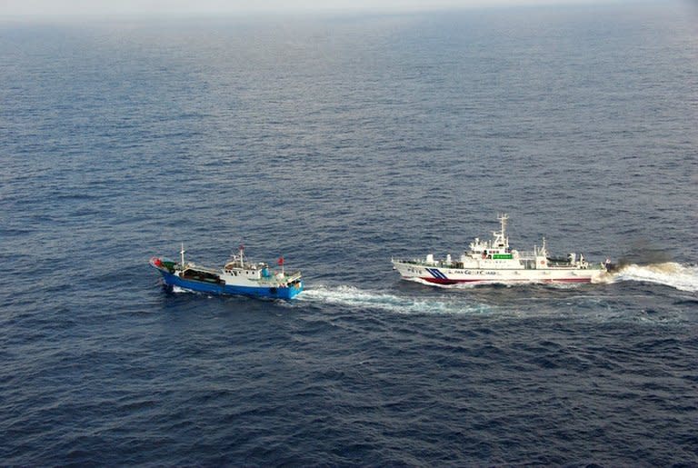 A Japan Coast Guard vessel (R) follows a Chinese fishing boat near Miyako island in Okinawa prefecture, in East China Sea, February 2, 2013. China and Japan have stepped up a war of words over the dispute in recent months, with Beijing's vessels regularly entering the waters around the Tokyo-controlled islands, stoking fears of armed conflict
