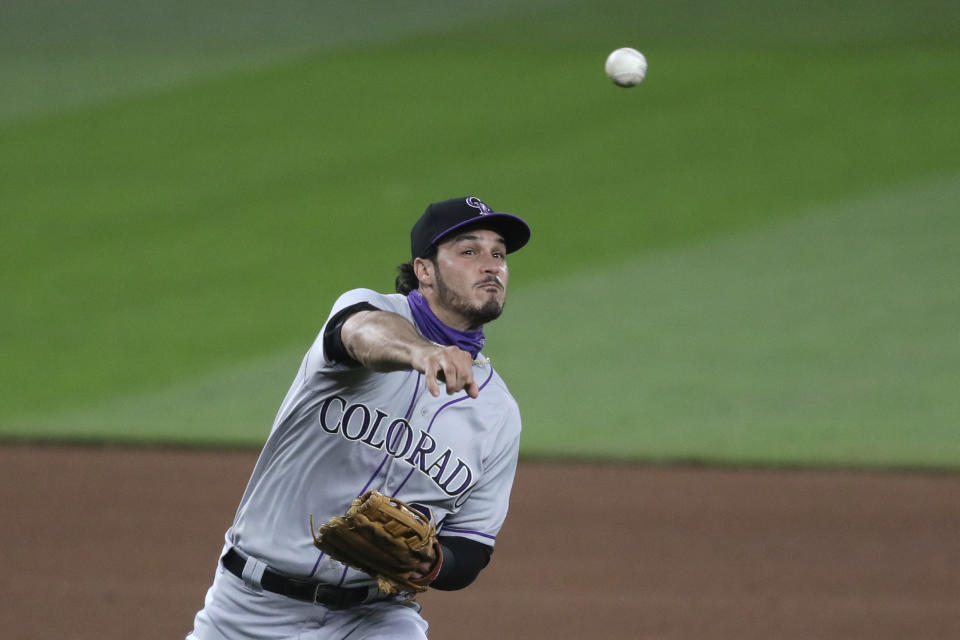 Colorado Rockies third baseman Nolan Arenado makes a throw against the Seattle Mariners in the fifth inning of a baseball game Friday, Aug. 7, 2020, in Seattle. (AP Photo/Elaine Thompson)