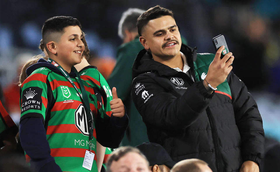 Latrell Mitchell, pictured here taking a photo with a young South Sydney Rabbitohs fan.