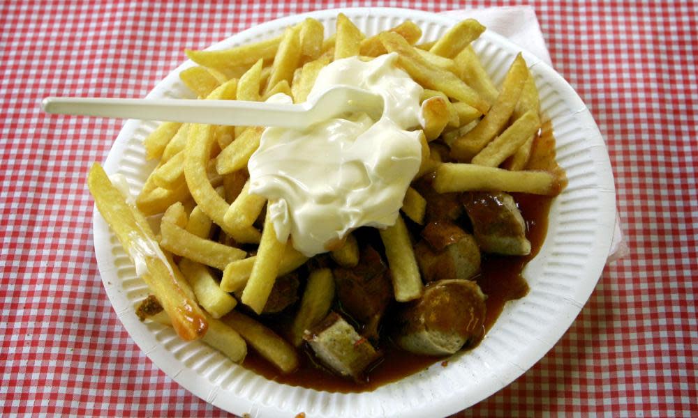 Chips and sausages on paper plate