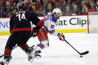 New York Rangers' Vincent Trocheck (16) controls the puck in front of Carolina Hurricanes' Jaccob Slavin (74) during the first period in Game 4 of an NHL hockey Stanley Cup second-round playoff series in Raleigh, N.C., Saturday, May 11, 2024. (AP Photo/Karl B DeBlaker)
