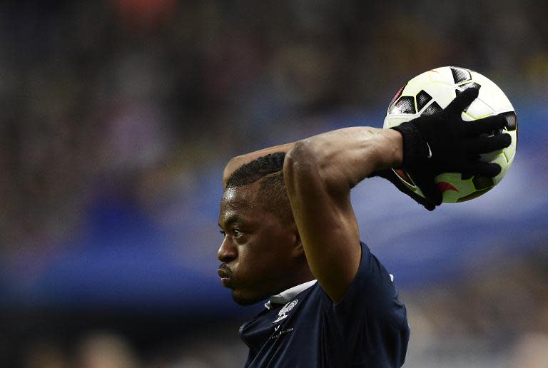 France's defender Patrice Evra throws the ball in during the friendly football match France vs Brazil, on March 26, 2015 at the Stade de France in Saint-Denis, north of Paris