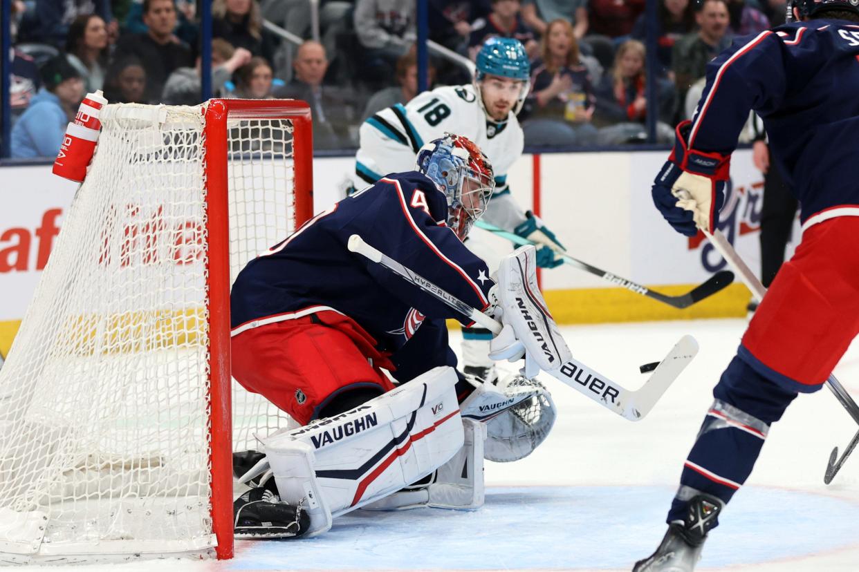 Columbus Blue Jackets goalie Daniil Tarasov, left, makes a stop in front of San Jose Sharks forward Filip Zadina during the first period of an NHL hockey game in Columbus, Ohio, Saturday, March 16, 2024. (AP Photo/Paul Vernon)
