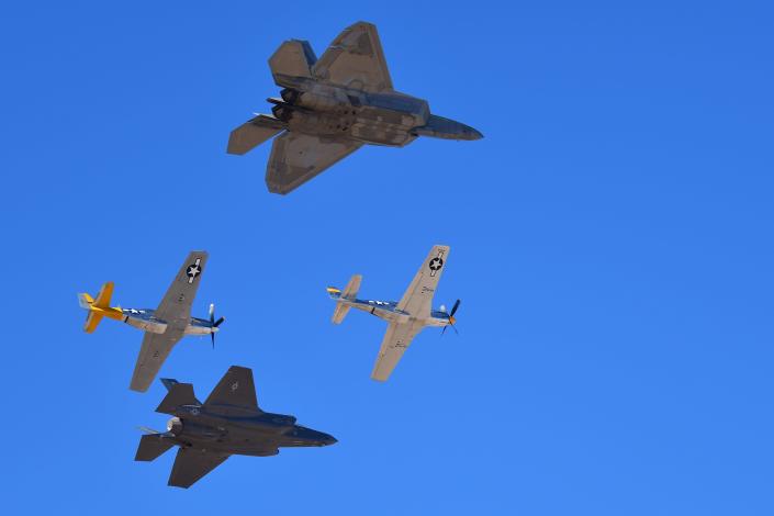 Maj. Joshua Gunderson, F-22 Raptor Demonstration Team pilot and commander, flies in formation with Maj. Kristin Wolfe, F-35A Lightning II Demonstration Team pilot and commander, and two P-51 Mustangs during the 2022 Heritage Flight Training Course at Davis-Monthan Air Force Base, Arizona, March 6, 2022. During the course, aircrew practice ground and flight training to enable civilian pilots of historic military aircraft and U.S. Air Force pilots of current fighter aircraft to fly safely in formations together. The HFTC is also intended to certify airshow pilots for the upcoming airshow season.