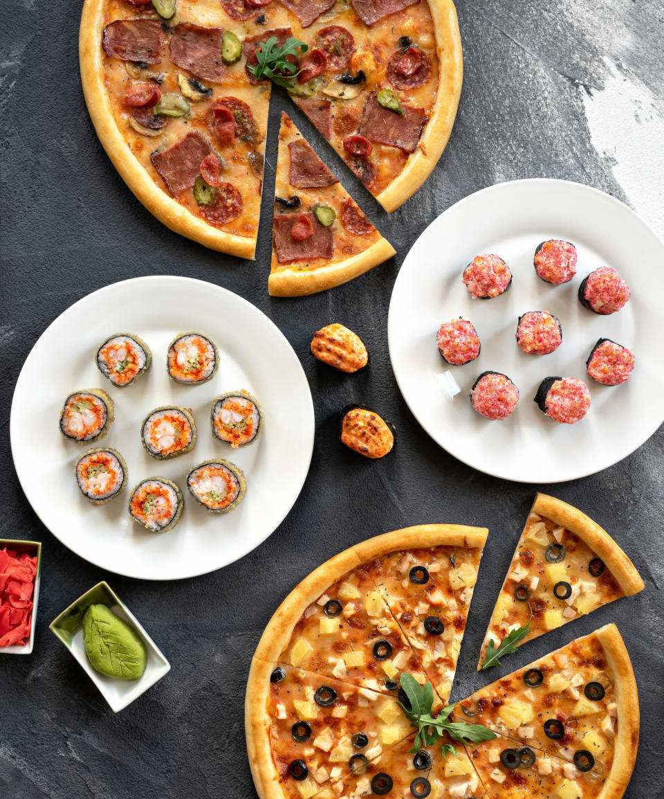 overhead shot of sushi and pizza