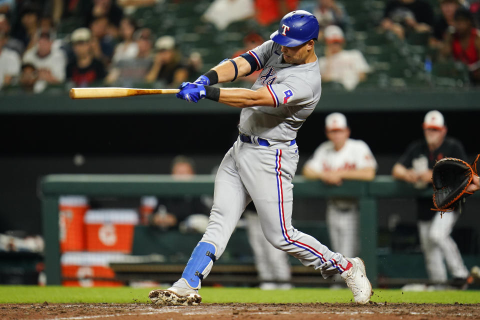 Texas Rangers' Nathaniel Low hits a three-run home run off Baltimore Orioles relief pitcher Nick Vespi during the eighth inning of a baseball game, Tuesday, July 5, 2022, in Baltimore. Rangers' Corey Seager and Jonah Heim scored on the home run. The Orioles won 10-9 in ten innings. (AP Photo/Julio Cortez)