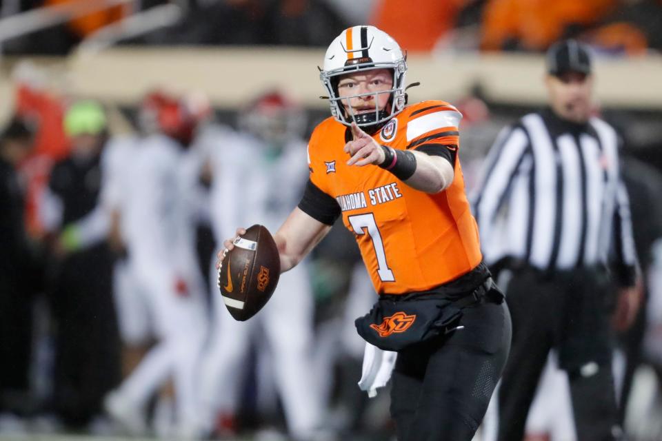 OSU quarterback Alan Bowman (7) rolls out looking to make a pass during a 45-13 win against Cincinnati on Saturday at Boone Pickens Stadium in Stillwater.