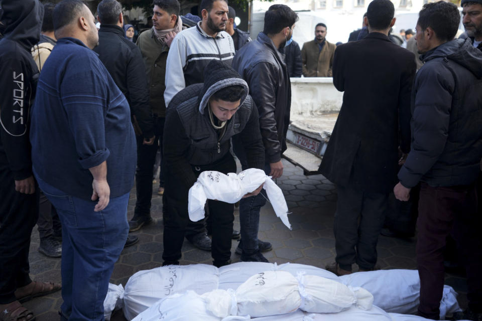 Palestinians mourn their relatives killed in the Israeli bombardment of the Gaza Strip in Deir al Balah, Monday, Feb. 5, 2024. (AP Photo/Adel Hana)