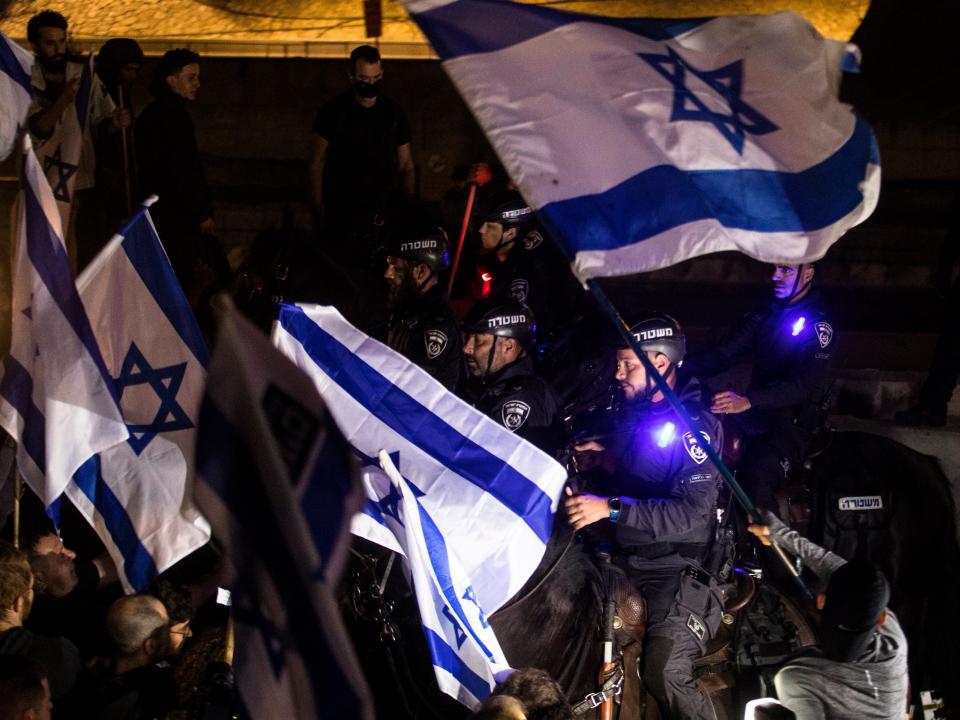 Protesters clash with officers on horses as they are blocking a main highway during a mass rally against the government proposed judicial overhaul on March 4, 2023 in Tel Aviv, Israel.