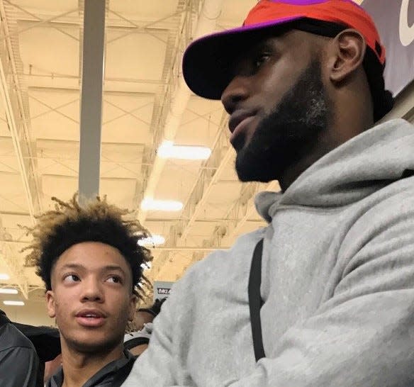 Alabama basketball guard Mark Sears stands next to LeBron James at an AAU game years ago.