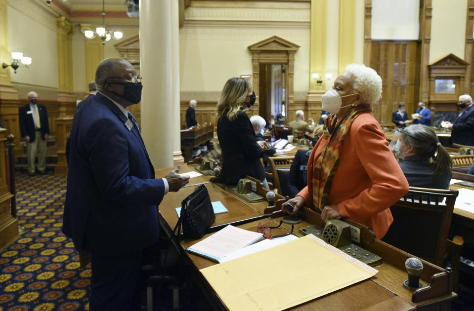 FILE - In this Tuesday, Jan. 12, 2021, file photo, State Sens. Ed Harbison, left, D-Columbus, and Minority Leader Gloria Butler, D-Stone Mountain, confer inside the Senate Chambers during the second day of the 2021 legislative session at the Georgia State Capitol, in Atlanta. Butler says some achievements in Georgia’s 2021 session were “progress,” but says good work was “overshadowed” by the state’s new voting law and other Republican priorities. (Hyosub Shin/Atlanta Journal-Constitution via AP, File)