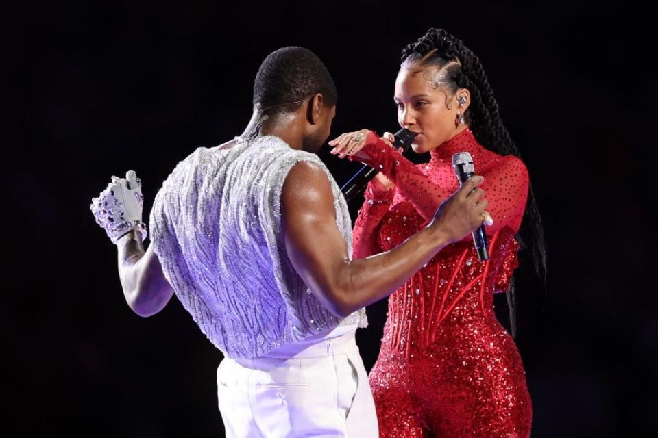 Usher and Alicia Keys perform onstage during the halftime show at Super Bowl LVIII.