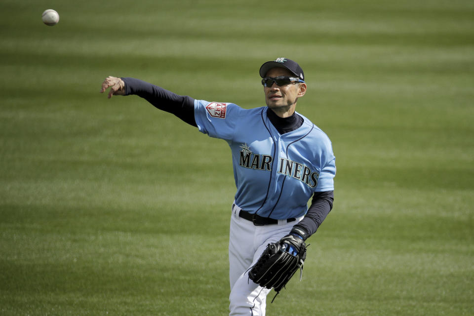 Seattle Mariners right fielder Ichiro Suzuki warms up in the outfield before the second inning of a spring training baseball game against the Oakland Athletics, Friday, Feb. 22, 2019, in Peoria, Ariz. (AP Photo/Charlie Riedel)