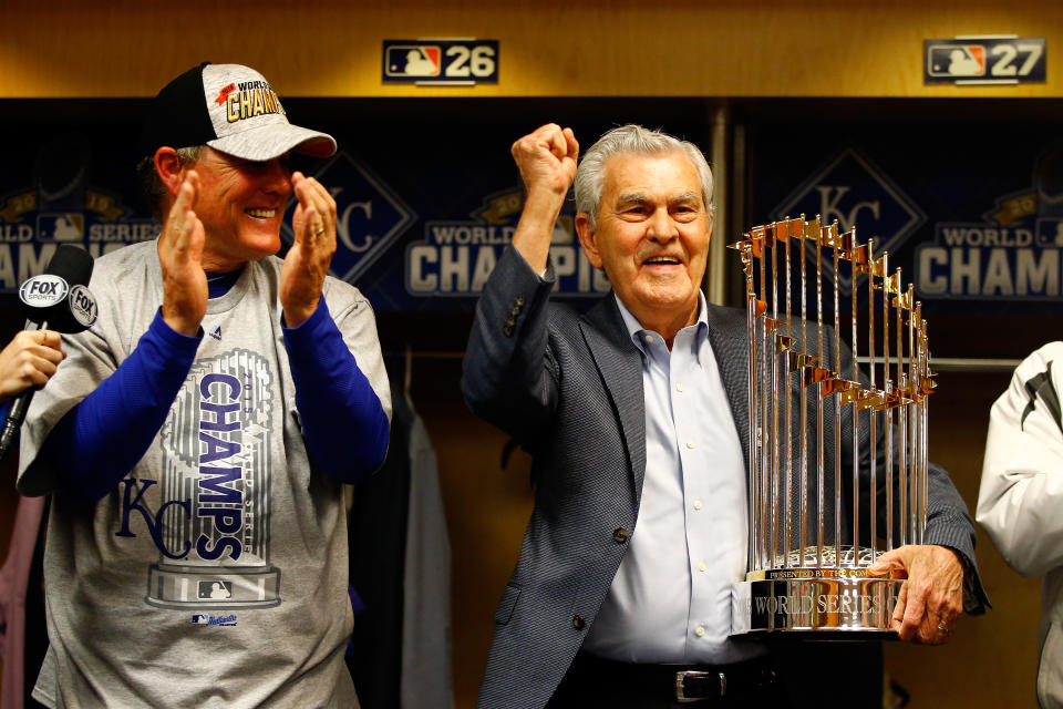 Kansas City Royals owner David D. Glass, right, holds the Commissioner's Trophy after the Royals beat the New York Mets in the 2015 World Seires. (Photo by Al Bello/Getty Images)