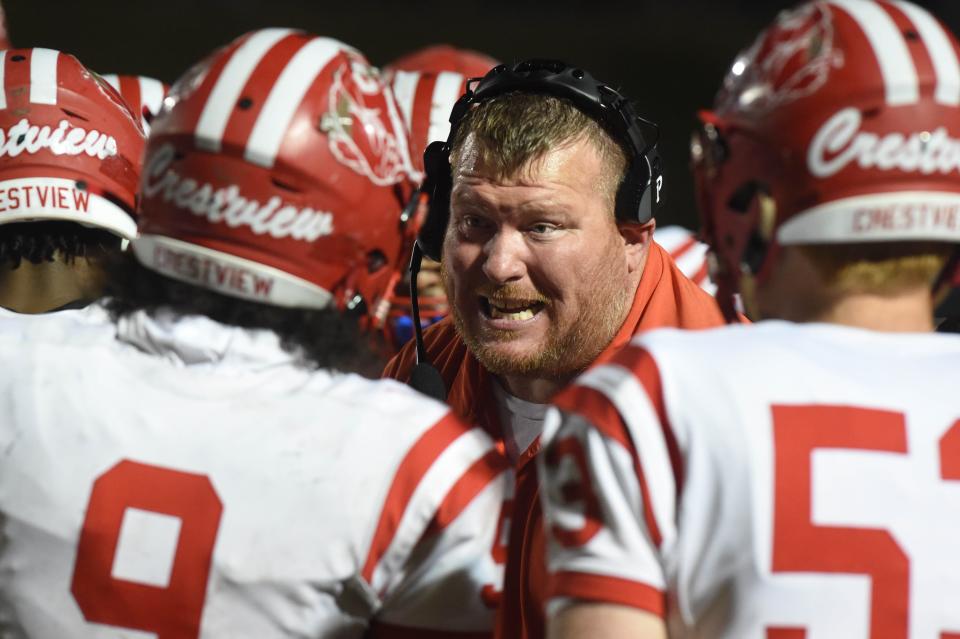 Crestview High School Coach Thomas Grant talks to his team during a time out in the Bulldog's playoff game against Niceville High School on Friday, Nov. 11, 2022.