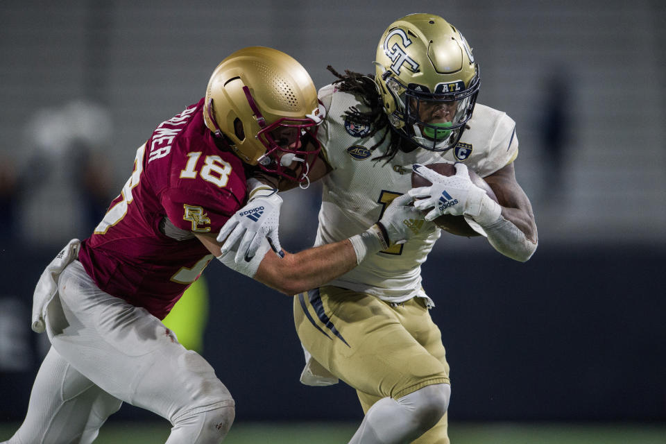 Boston College defensive back Mike Palmer (18) tackles Georgia Tech running back Jahmyr Gibbs (1) during the second half of an NCAA college football game, Saturday, Nov. 13, 2021, in Atlanta. Boston College won 41-30. (AP Photo/Danny Karnik)