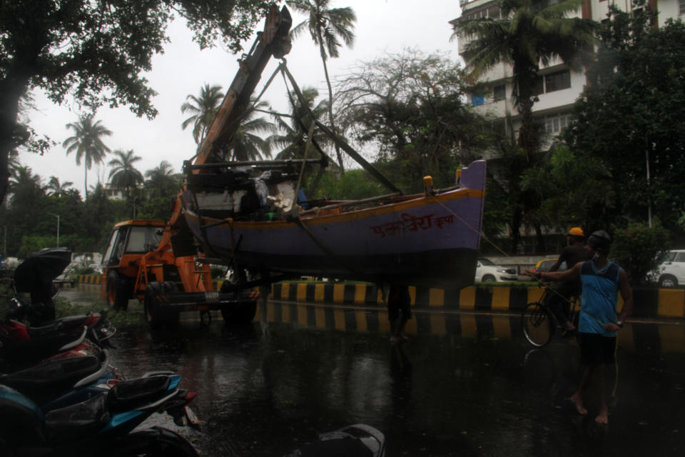 MUMBAI, INDIA - JUNE 03: Fishermen relocate a boat as part of precautions against Cyclone Nisarga in Mumbai, India on June 03, 2020. A storm in the Arabian Sea off India's west coast intensified into a severe cyclone on Wednesday, gathering speed as it barreled toward India's financial capital of Mumbai. Nisarga was forecast to drop heavy rains and winds gusting up to 120 kilometers (75 miles) per hour when it makes landfall Wednesday afternoon as a category 4 cyclone near the coastal city of Alibagh, about 98 kilometers (60 miles) south of Mumbai, India's Meteorological Department said. (Photo by Imtiyaz Shaikh/Anadolu Agency via Getty Images)