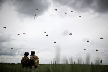 Paratroopers jump during a commemorative parachute jump over Sannverville as France prepares to commemorate the 75th anniversary of the D-Day