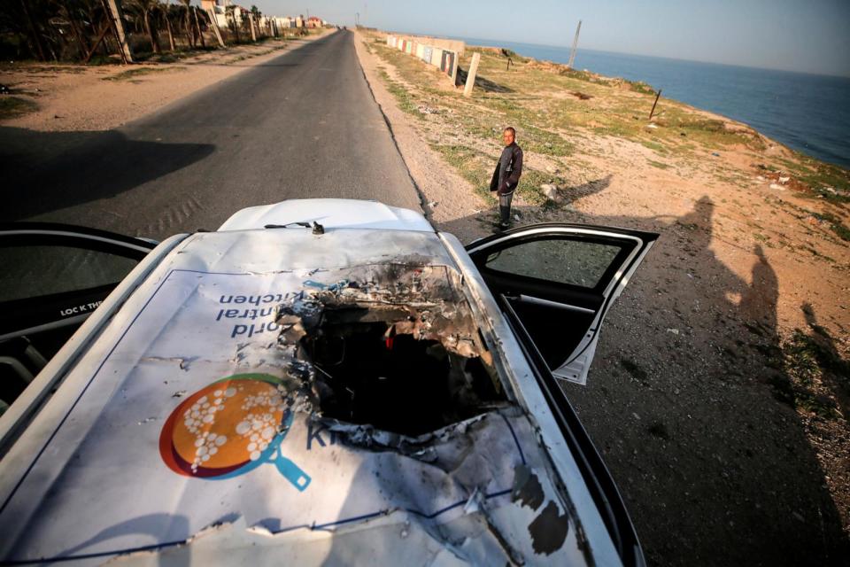 PHOTO: Palestinians are standing next to a vehicle in Deir Al-Balah, in the central Gaza Strip, on April 2, 2024, where employees from the World Central Kitchen (WCK), including foreigners, were killed in an Israeli airstrike, according to the NGO.  (Majdi Fathi/Associated Press)