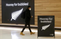 A passenger prepares at Sydney Airport, in Sydney, Australia, Monday, April 19, 2021, to catch a flight to New Zealand as the much-anticipated travel bubble between Australia and New Zealand opens. (AP Photo/Rick Rycroft)