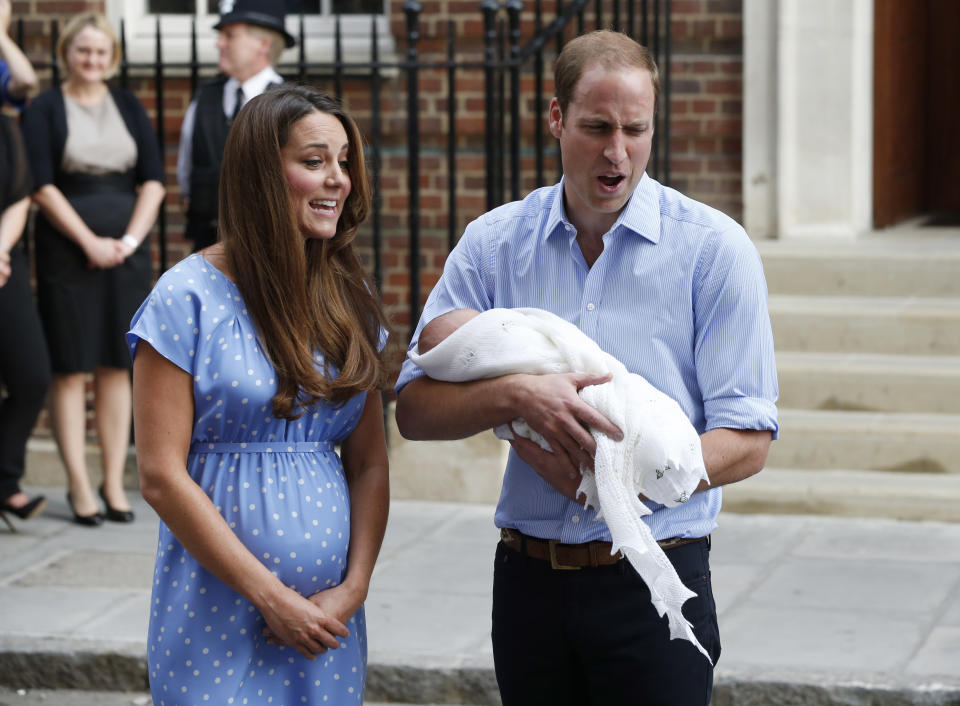 Britain's Prince William and Kate, Duchess of Cambridge hold the Prince of Cambridge, Tuesday July 23, 2013, as they pose for photographers outside St. Mary's Hospital exclusive Lindo Wing in London where the Duchess gave birth on Monday July 22. The Royal couple are expected to head to London’s Kensington Palace from the hospital with their newly born son, the third in line to the British throne. (AP Photo/Lefteris Pitarakis)