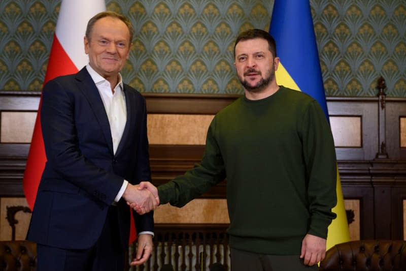 Ukrainian President Volodymyr Zelensky (R) and Polish Prime Minister Donald Tusk (L) shakes hands ahead of a meeting at the Mariinskyi Palace. -/Ukraine Presidency/dpa