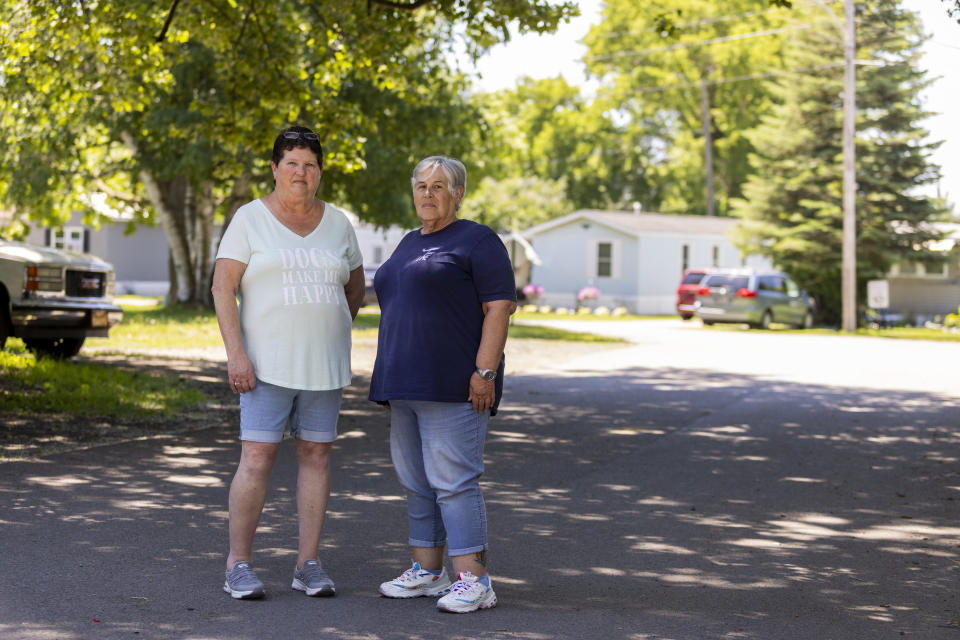 Sharon Ruth, left, and Sandy Lees pose for a portrait in the Ridgeview Homes mobile home community in Lockport, N.Y., June 23, 2022, Ruth and Lees, president and vice president of their neighborhood association, have organized a rent strike in reaction to a proposed rent increase being introduced by new owners of the mobile home park. "We want change," said Lees. "We need the place to be safe. We need the place to be healthy." (AP Photo/Lauren Petracca)