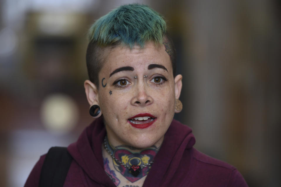 Danielle Silva, of Oakland, Calif., who identified herself as a Max Harris supporter, speaks to the media at the Alameda County Courthouse in Oakland, Calif., Tuesday April, 30, 2019. Two defendants, Derick Almena and Max Harris are standing trial on charges of involuntary manslaughter after a 2016 fire killed 36 people at a warehouse party they hosted in Oakland. (AP Photo/Cody Glenn)