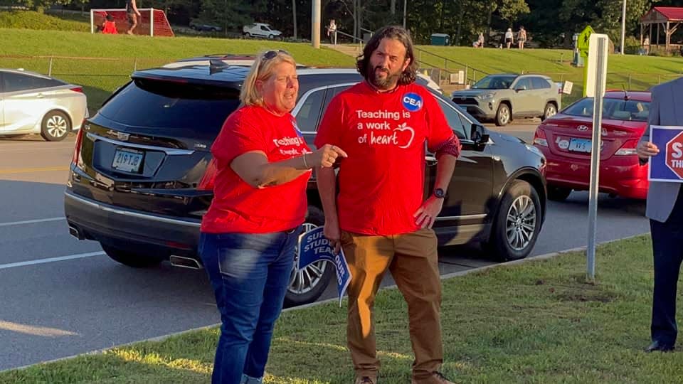 Connecticut Education Association President Kate Dias and Norwich Teachers League President Bill Priest speak to rally-goers on Tuesday.