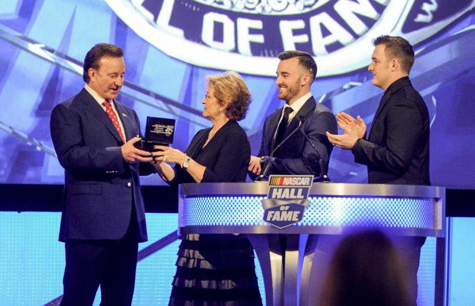 NASCAR Hall of Fame inductee Richard Childress receives the Hall of Fame ring from his wife, Judy, as grandsons, Austin Dillon and Ty Dillon, watch during the NASCAR Hall of Fame induction ceremony in Charlotte, N.C., Friday, Jan. 20, 2017. (AP Photo/Mike McCarn)