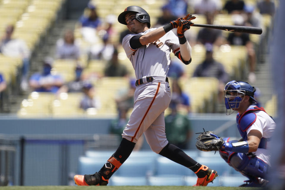 San Francisco Giants' Mauricio Dubon (1) hits a home run during the first inning of a baseball game against the Los Angeles Dodgers Sunday, May 30, 2021, in Los Angeles. Donovan Solano also scored. (AP Photo/Ashley Landis)