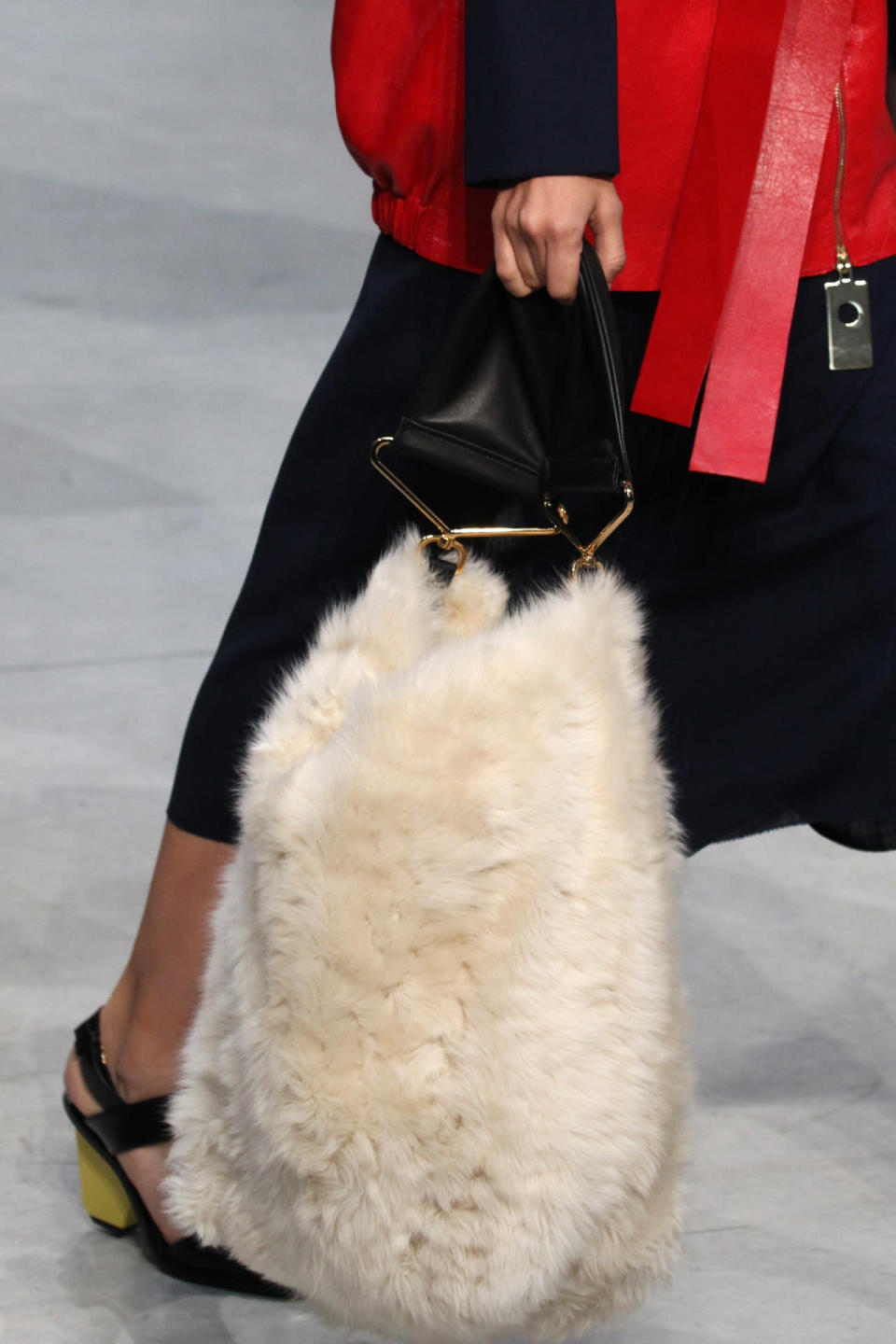 A model carries a giant, faux-fur tote at Marni’s spring 2016 show in Milan. (Photo: Getty Images.)