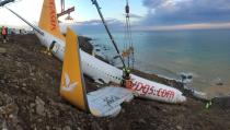 <p>A crane lifts Pegasus airplane which was stucked in mud as it skidded off the runway after landing in Trabzon Airport, Turkey early Sunday on Jan. 18, 2018. (Photo: Anadolu Agency/Getty Images) </p>