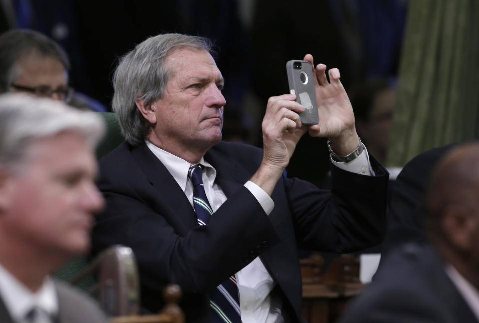 State Sen. Mark DeSaulnier, D-Concord, uses his cellphone to capture an image of Gov. Jerry Brown delivering his State of the State Address before a joint session of the Legislature at the Capitol in Sacramento, Calif., Wednesday, Jan. 22, 2014. Brown delivered a dual message to lawmakers, that a California resurgence is well underway but is threatened by economic and environmental uncertainties.(AP Photo/Rich Pedroncelli)