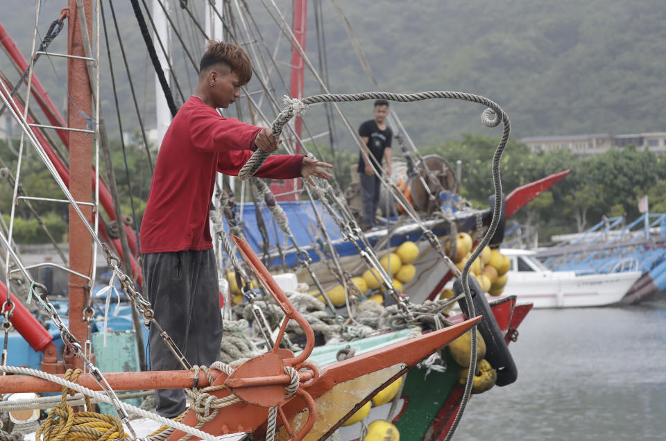 Fishermen fasten a boat as Typhoon Mawar approaches to Taiwan in Yilan County, eastern coast of Taiwan, Tuesday, May 30, 2023. Typhoon Mawar lashed Taiwan's eastern coast on Tuesday with wind, rains and large waves but largely skirted the island after giving a glancing blow to the northern Philippines. (AP Photo/Chiang Ying-ying)