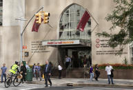 In this Sept. 26, 2019, photo, people pass the Weill Cornell Medicine center in New York. Prestigious universities around the world, including Cornell University, have accepted at least $60 million from the family that owns OxyContin maker Purdue Pharma over the past five years, even as the company has been embroiled in lawsuits over its role in the opioid epidemic, according to tax and charity records reviewed by The Associated Press. (AP Photo/Mark Lennihan)